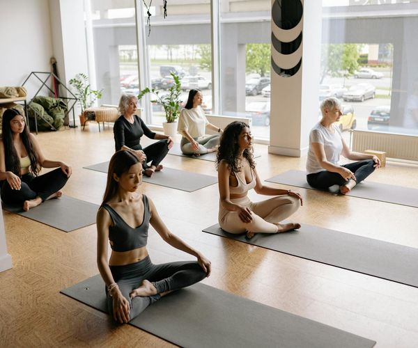 Diverse group of people smiling after a yoga class session.
